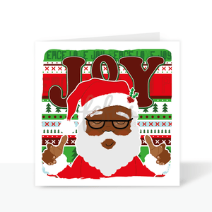 A vibrant Black Santa Christmas card featuring a smiling Santa in a holly-adorned hat. The background spells "Joy" in a colourful yet traditional design, capturing the warmth of the festive season. Hand-drawn and digitally illustrated by Fefus Designs, this card celebrates diversity and holiday cheer.